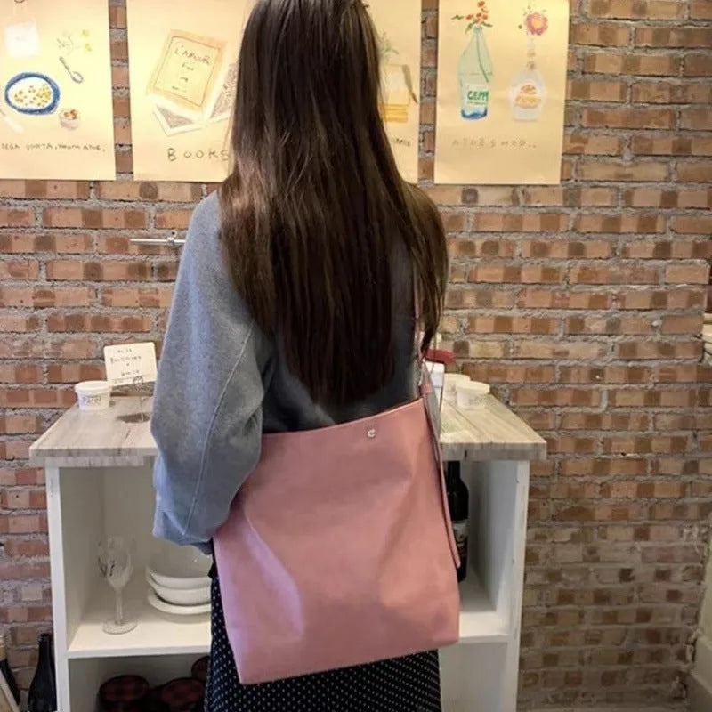 Pink corduroy one-shoulder commuter bag with dimensions 39cm by 32cm.