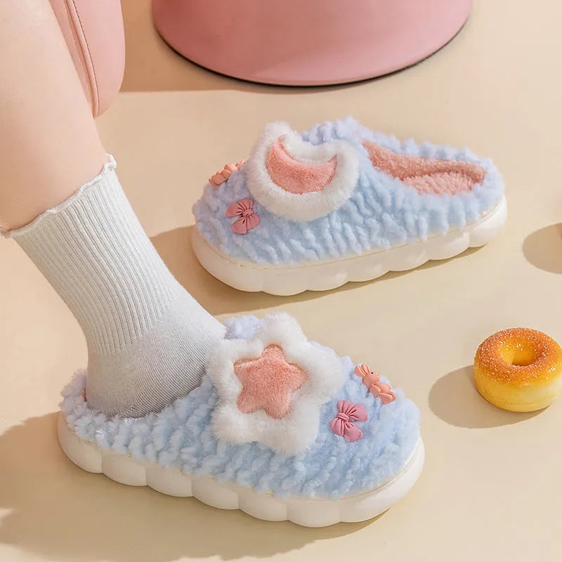 Light blue women's plush slippers with an animal pattern on the round toe holder and a thick fleece lining.