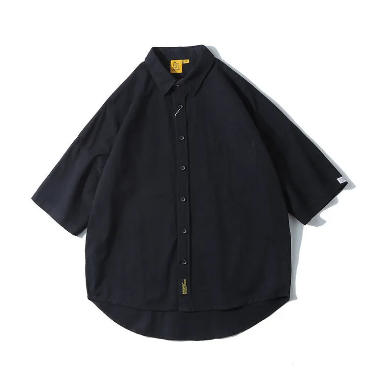 Man wearing a loose-fit cotton cardigan shirt in a solid colour, showcasing the Japanese-inspired summer style.