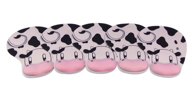 Super soft silicone cow pattern wrist rest mouse pad on a desk, showing non-slip base and ergonomic hand support.