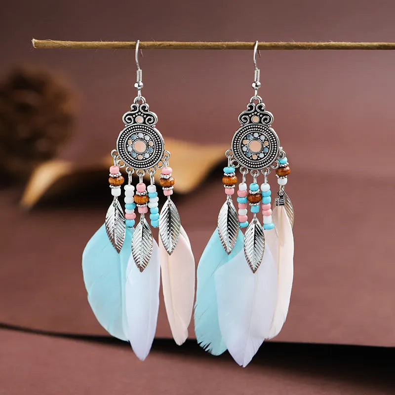 Round drop feather earrings in alloy with electroplated finish showing leaf shape and pattern details