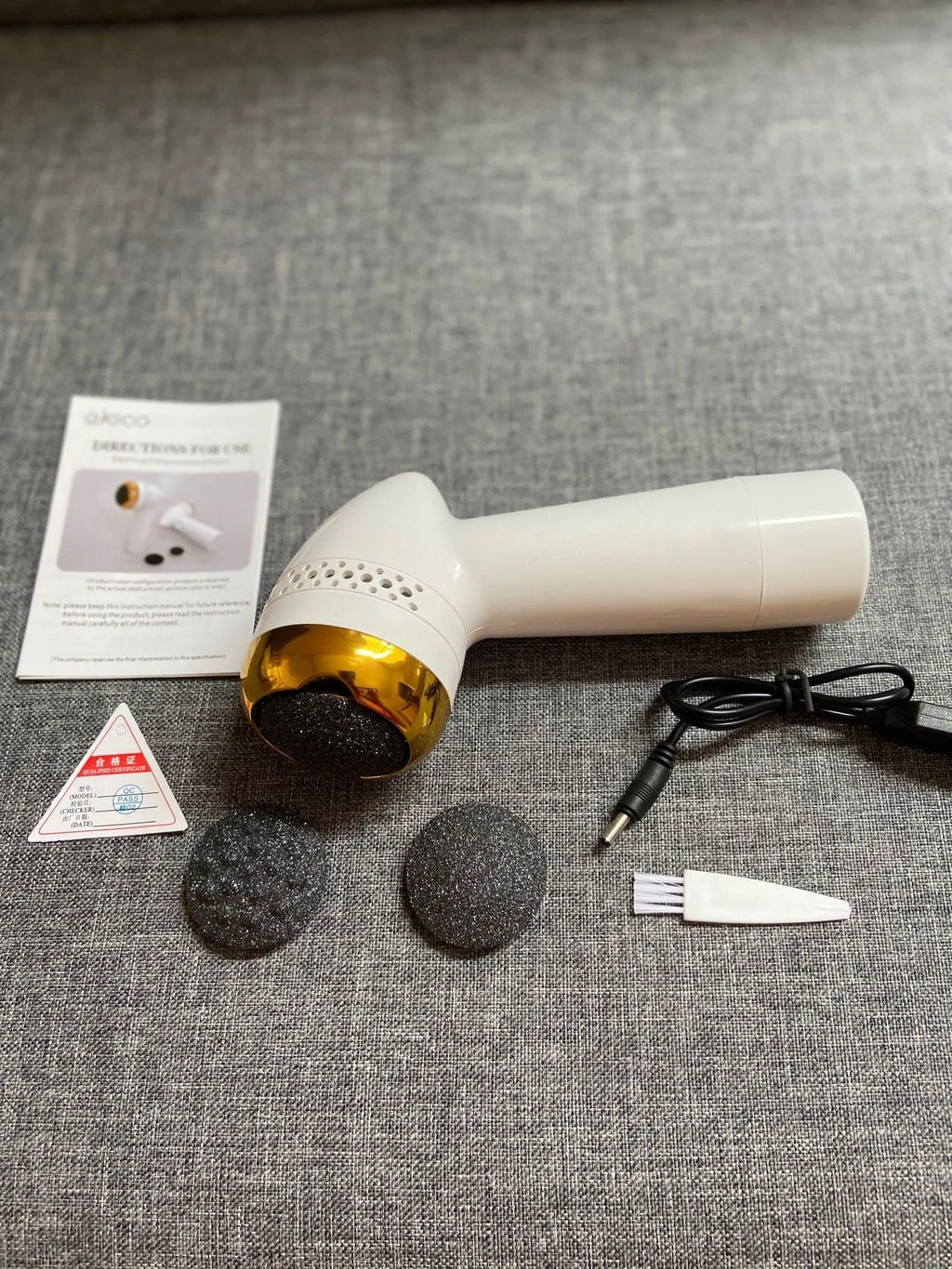 Electric vacuum foot grinder with a refined quartz grinding head in a gold finish.