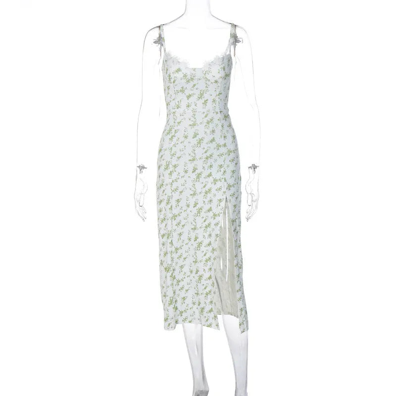 Women's blue lace flower print long suspender dress with a high leg slit on a model.