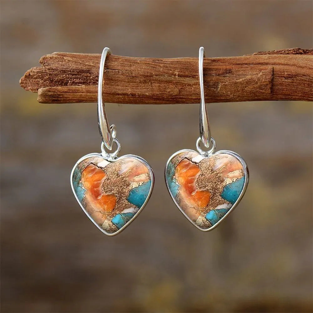 Silver alloy vintage bohemian water droplet pendant drop earrings on light background