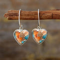 Silver alloy vintage bohemian water droplet pendant drop earrings on light background