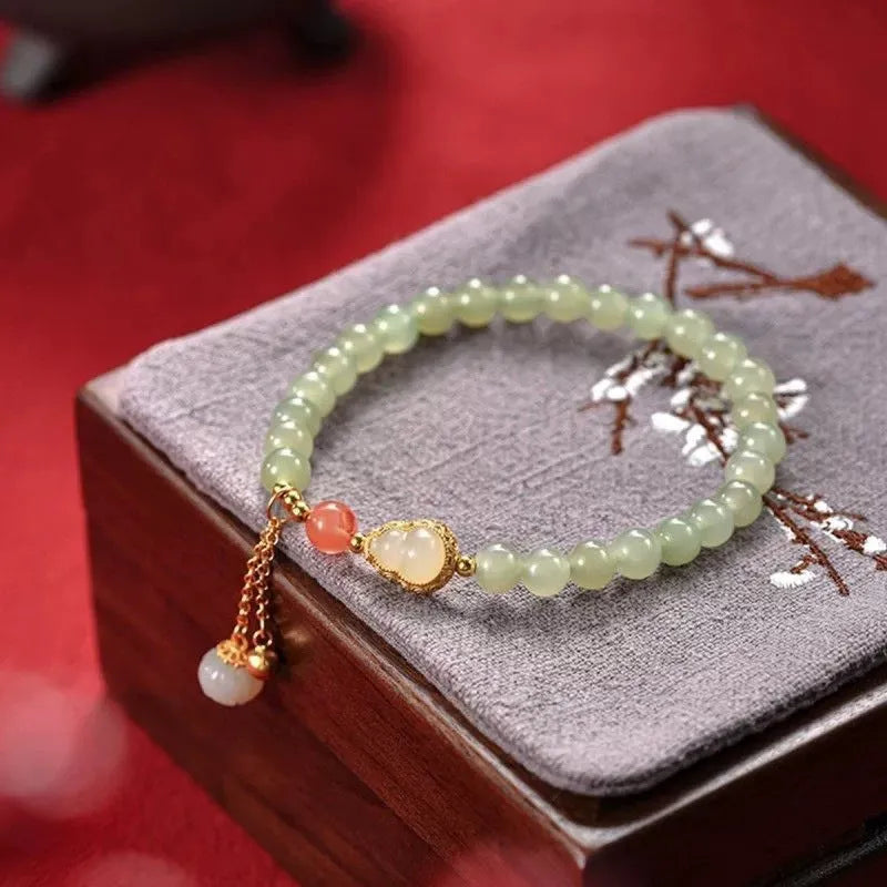 Qingshui jade women's bracelet with gold gourd design and fu character symbol