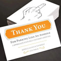 Box of paper illegal parking reminder cards featuring a printed middle finger design.