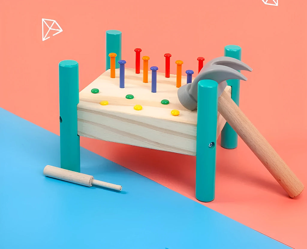 Wooden knock table with 17 colourful nails, hammer and reverse knock on khaki wood base