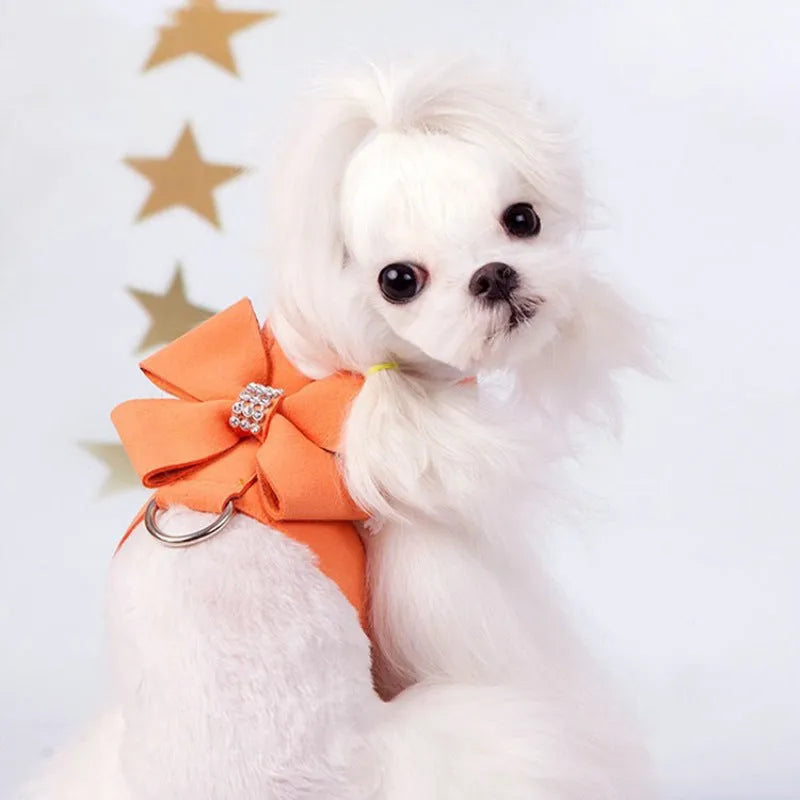 A cute pink microfiber puppy chest strap with a bowknot, showing the adjustable design.