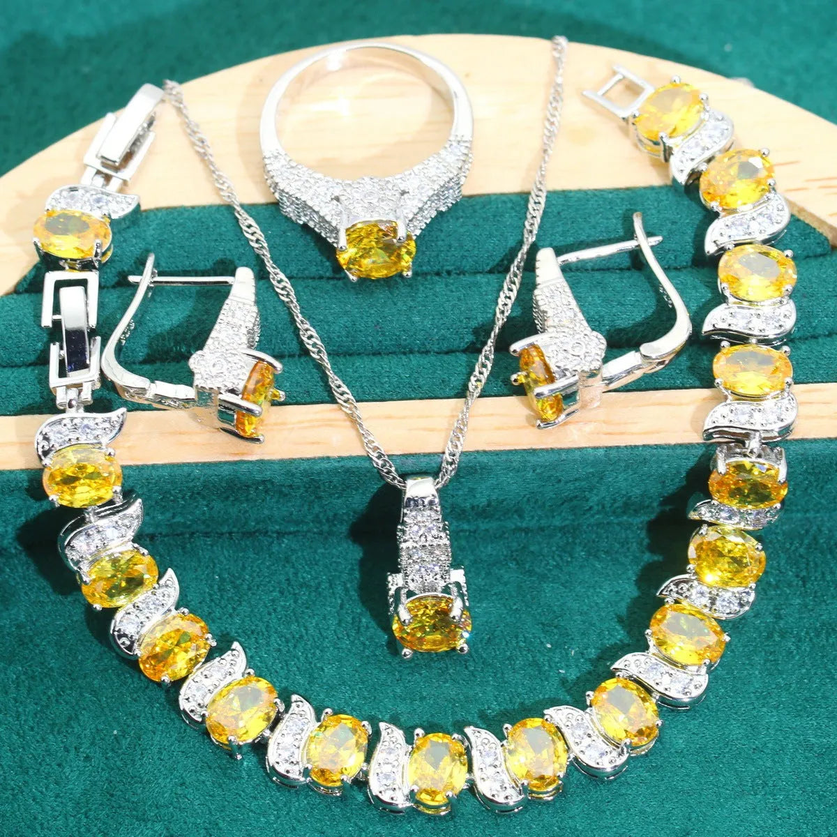 Bridal zircon and alloy four-piece jewellery set showing necklace, earrings, bracelet, and ring in white colour