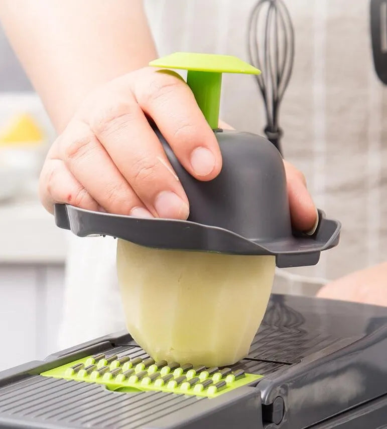 Multi-blade vegetable cutter with wheat straw body and seven stainless steel blades for slicing and dicing on a kitchen counter.