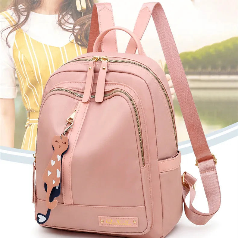 Black casual nylon backpack with double shoulder straps and external pocket.