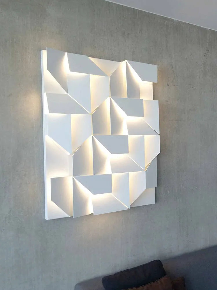 Minimalist rectangular wall lamp in matte white finish, shown in a living room setting.