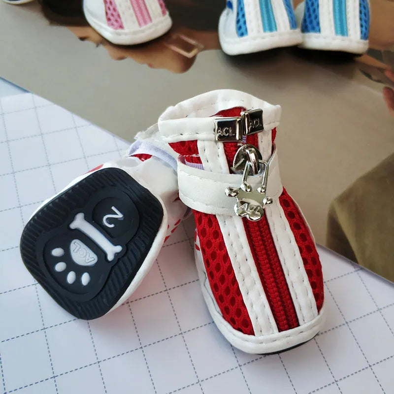 Set of four blue cloth dog shoes with zippers and non-slip soles for small to medium dogs.