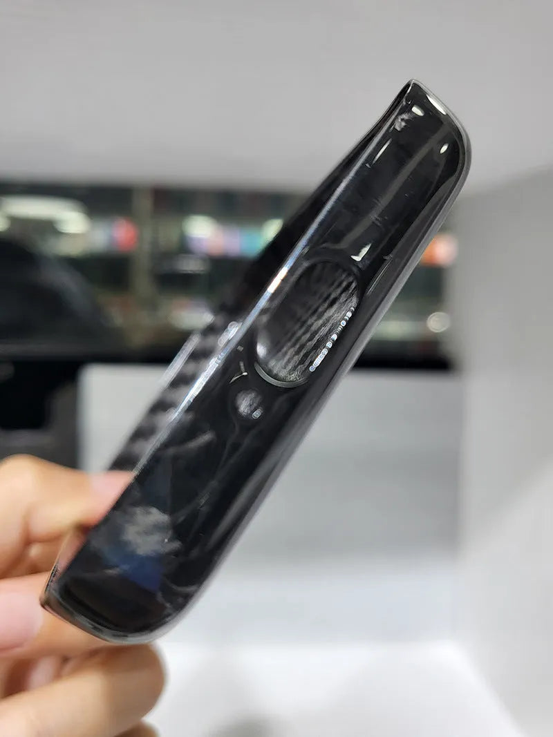 Black Kevlar hard shell case for Apple MagSafe power bank, shown in 3K round hole bright finish.