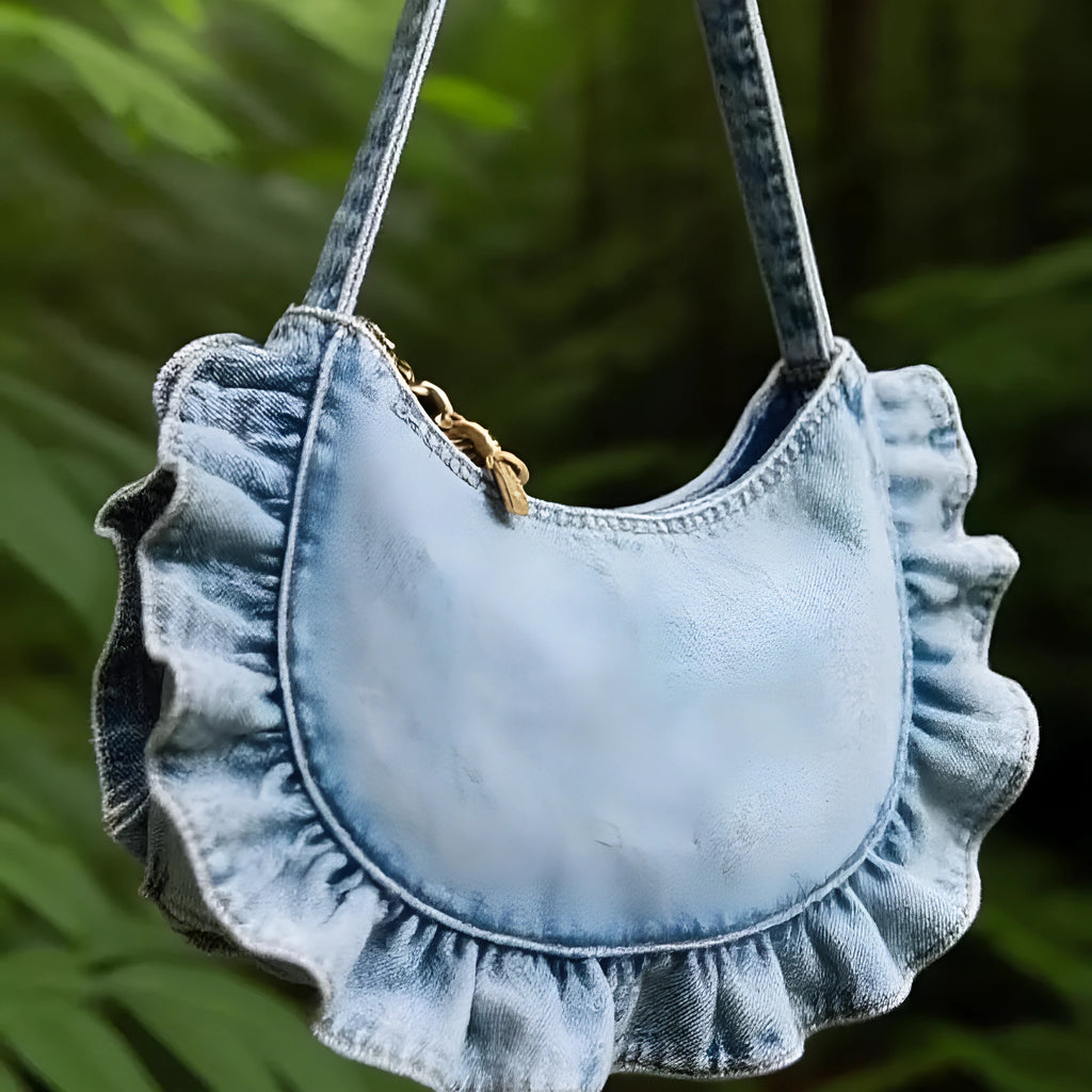 Denim blue cross-body bag with lace pleated trim and single shoulder strap, bucket shape.