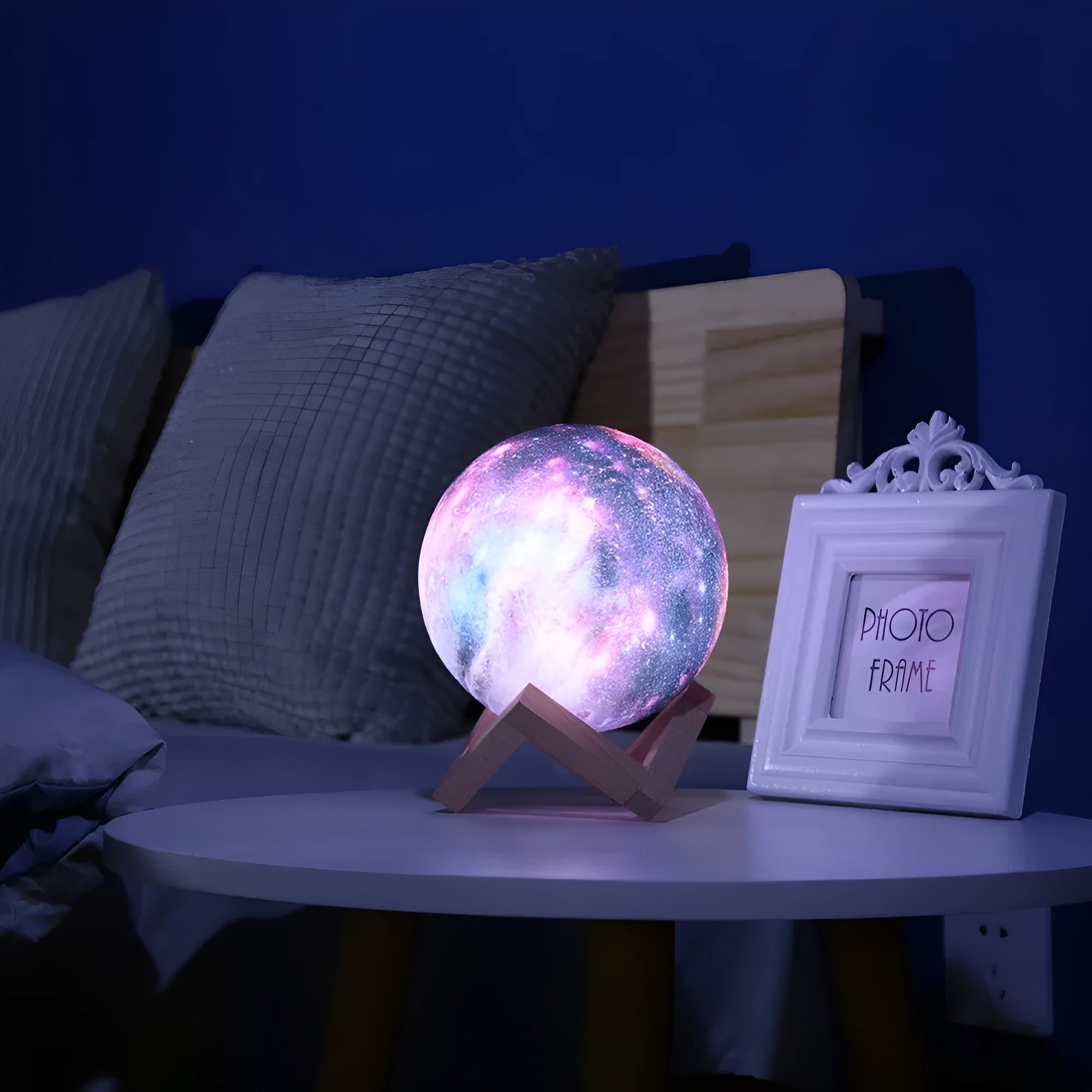 3D-printed lunar sphere night light showing colour-changing LEDs with a remote control.