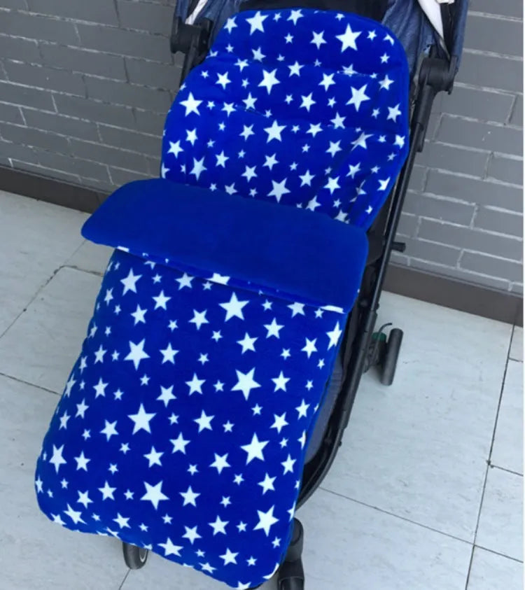 Envelope-style baby stroller sleeping bag in beige colour with thick filling, shown next to a pram.