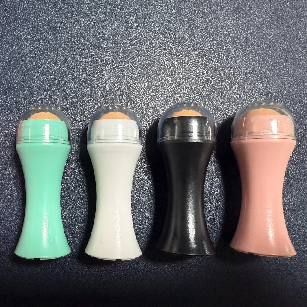A small portable volcanic stone roller for absorbing facial oil, shown in various colours on a neutral background.