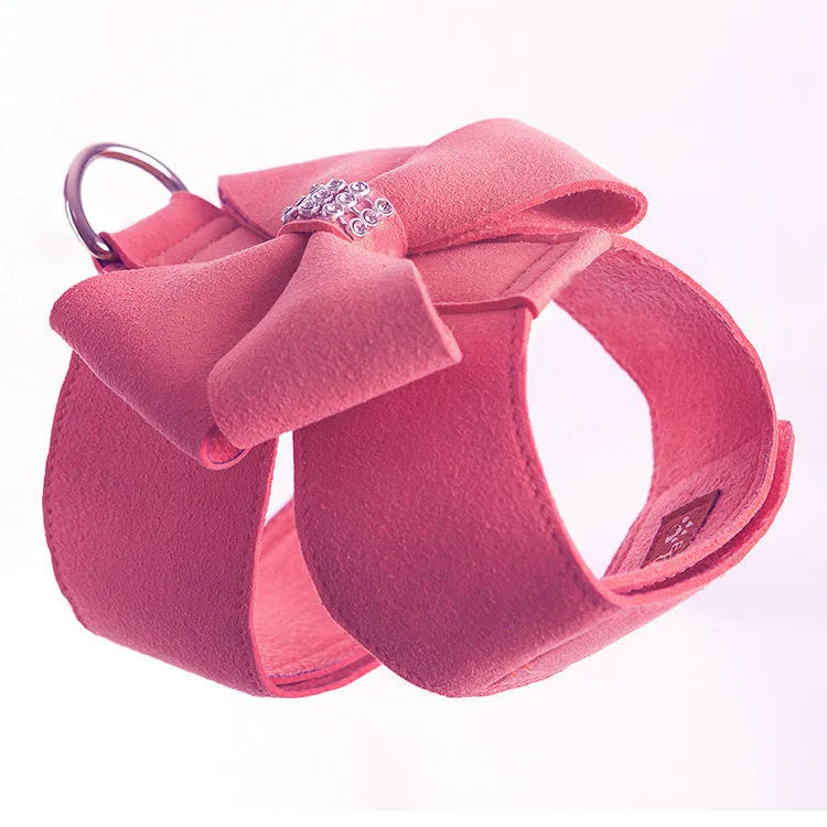 A cute pink microfiber puppy chest strap with a bowknot, showing the adjustable design.
