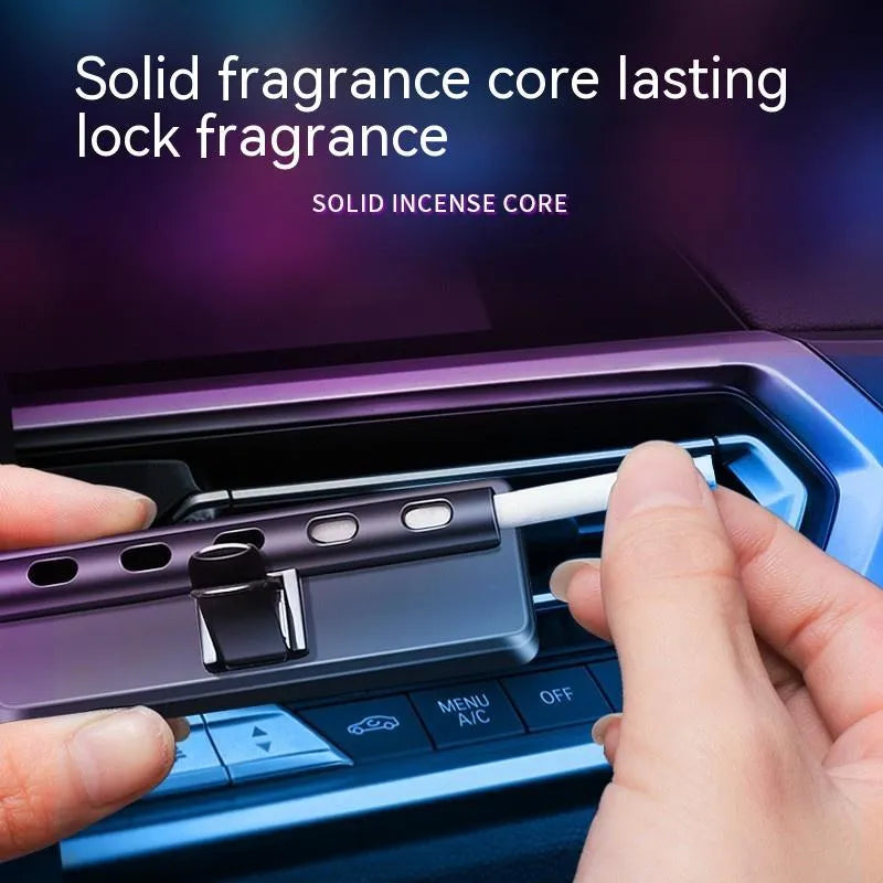 Black car air vent perfume diffuser with LED mood light mounted on vehicle ventilation louvre