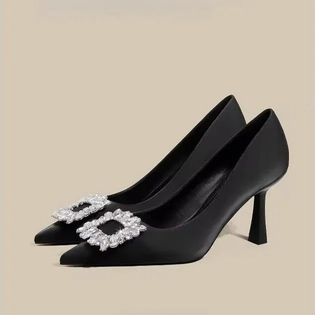 Women's creamy-white pointed toe stiletto high heel pumps for formal wear.