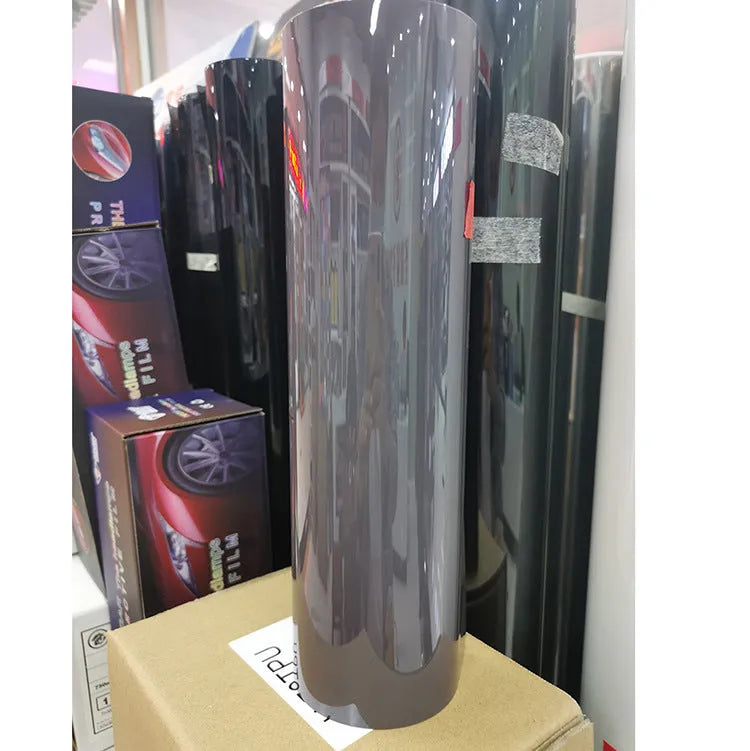A roll of 30cm wide dark grey car lamp protective film for headlight and taillight protection.