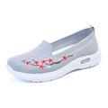 Women's wine red embroidered low heel pumps with round toe and anti-slip sole.