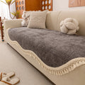 Ivory white non-slip short plush polyester sofa cover with tassle fringe on a sofa seat