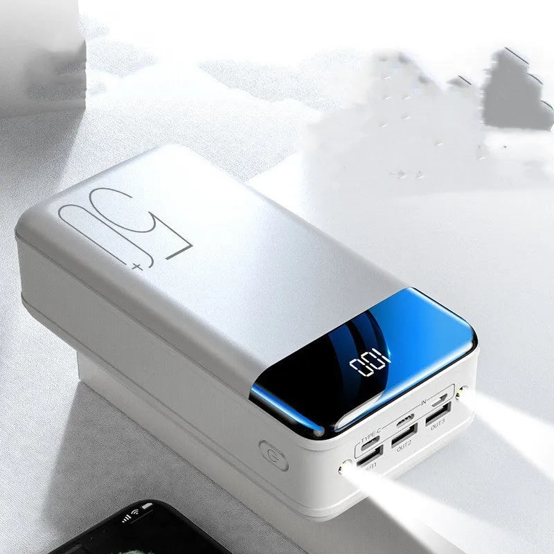 Black large capacity 50000mAh portable power bank with three USB output ports showing size scale.