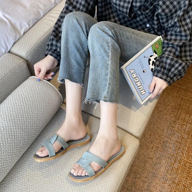 Women's PVC cross-strap sandals with toe ring and non-slip sole in light blue colour.