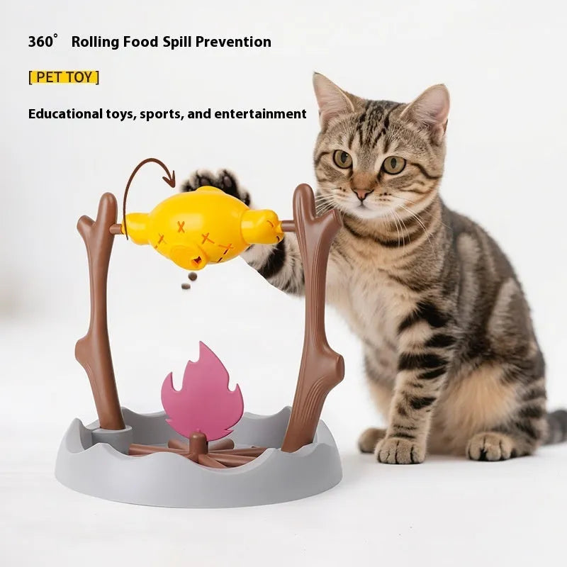 Barbecue-style rolling cat feeder toy with treat compartments, measuring 30cm cubed on a floor.