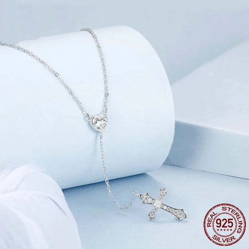 Close-up of a sterling silver V-neck love cross pendant on an O-ring chain.
