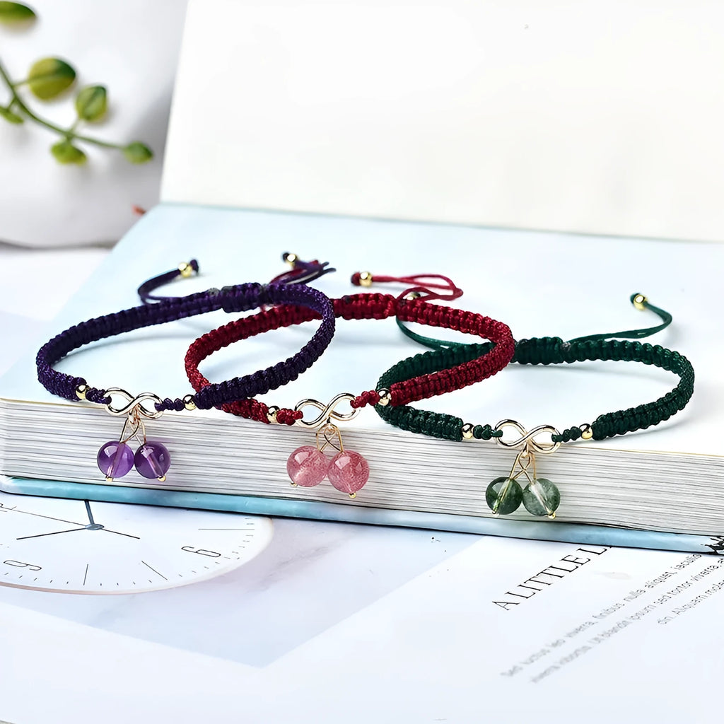 Women's Natural Strawberry Quartz bracelet with fruit-shaped cherry beads on a wrist.