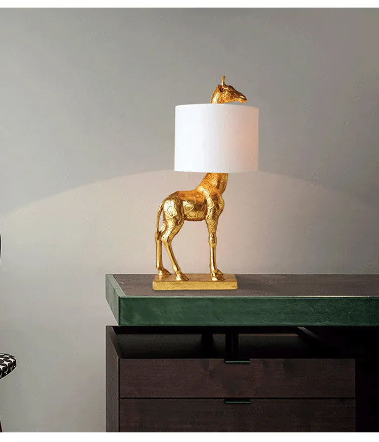 Giraffe table lamp with 66cm height in gold or white finish for bedside and desk lighting