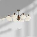 Traditional persimmon glass chandelier with multiple chrome arms and white glass lampshades hanging from a ceiling.