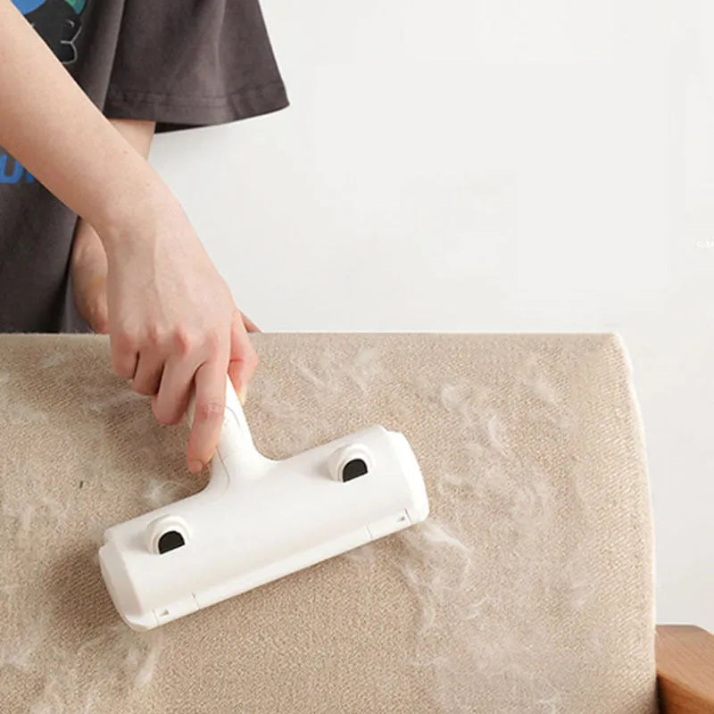 White reusable pet hair remover roller on fabric furniture