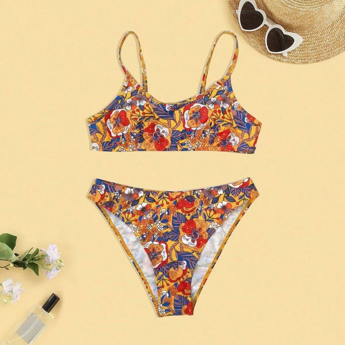 Plus size women's floral print strap bikini swimsuit set in brief style on a mannequin