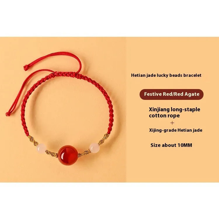 Hand-woven wine red rope bracelet with Hetian jade lucky beads and ethnic symbols.