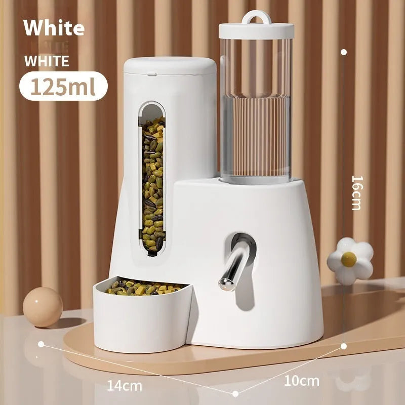 White, blue, and pink automatic hamster water feeder with attached food basin.