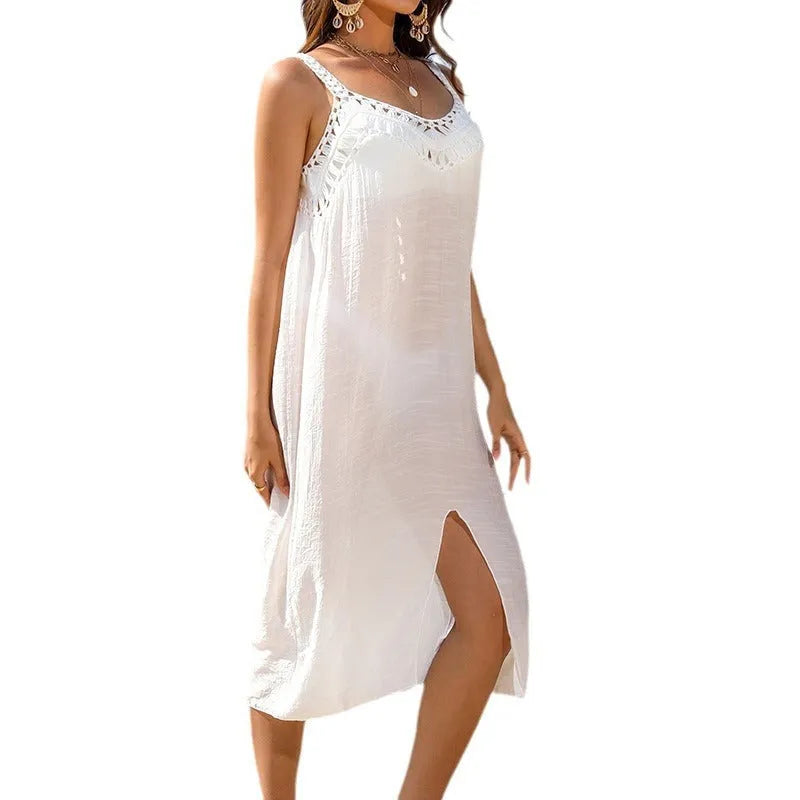 White women's suspender beach dress with hollow crochet weaving and a bottom slit.