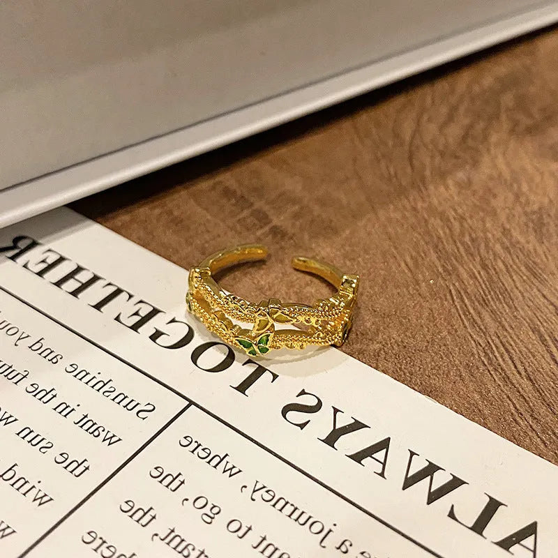 Copper butterfly women's ring with dripping oil texture and an open loop design.