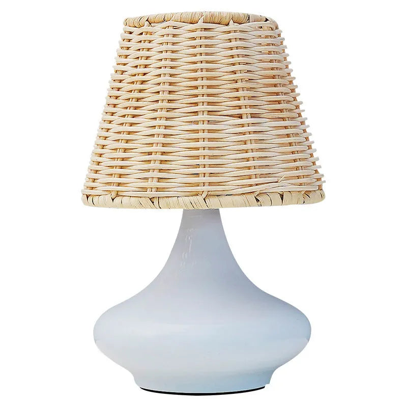 Bamboo desk lamp with black iron art base, USB cable, and warm light glow on a wooden table