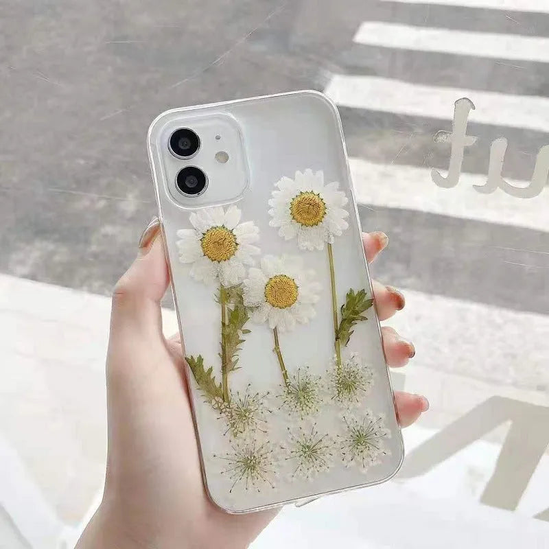 White epoxy daisy floral design on a clear TPU protective case for iPhone models.