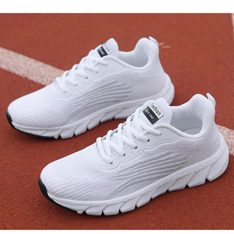 Low-top black and white running sneaker with cross strap and round toe on MD sole.