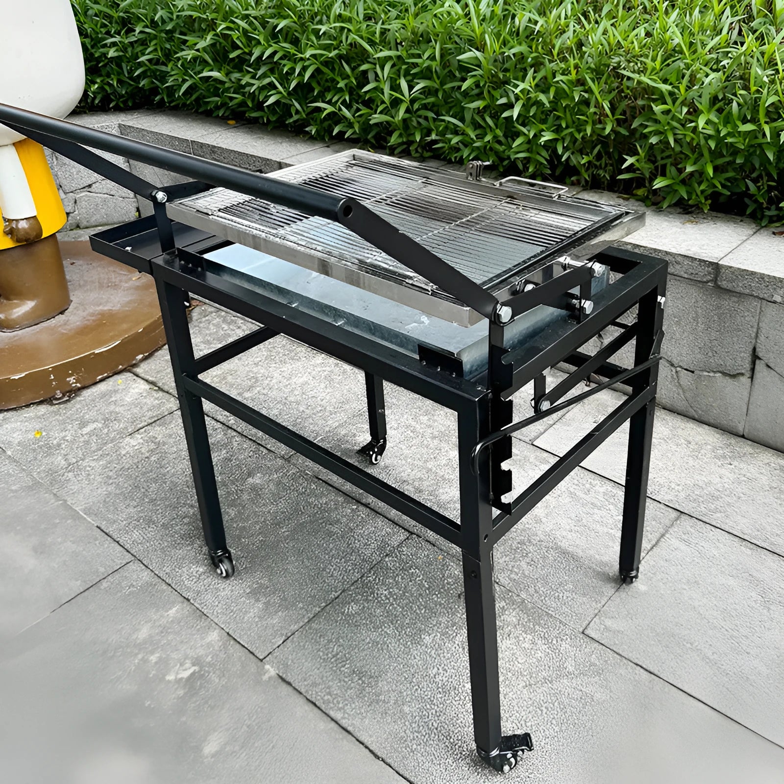 Foldable charcoal BBQ stove with detachable frame and adjustable legs for outdoor cooking.