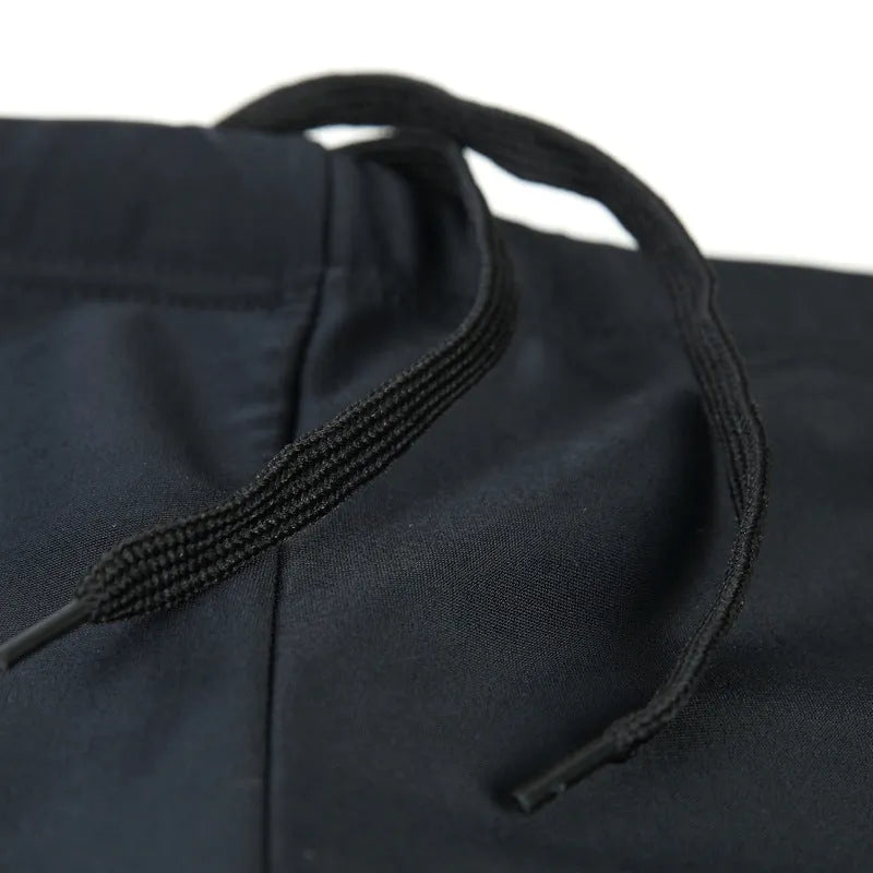 Men's plus-size blue fire pattern swimming trunks and cap on a black background.
