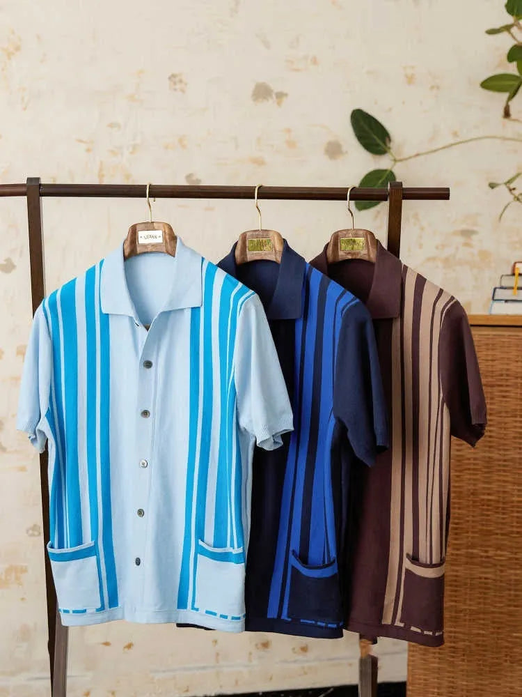 A royal blue striped short-sleeved polo cardigan with a lapel collar, laid flat.