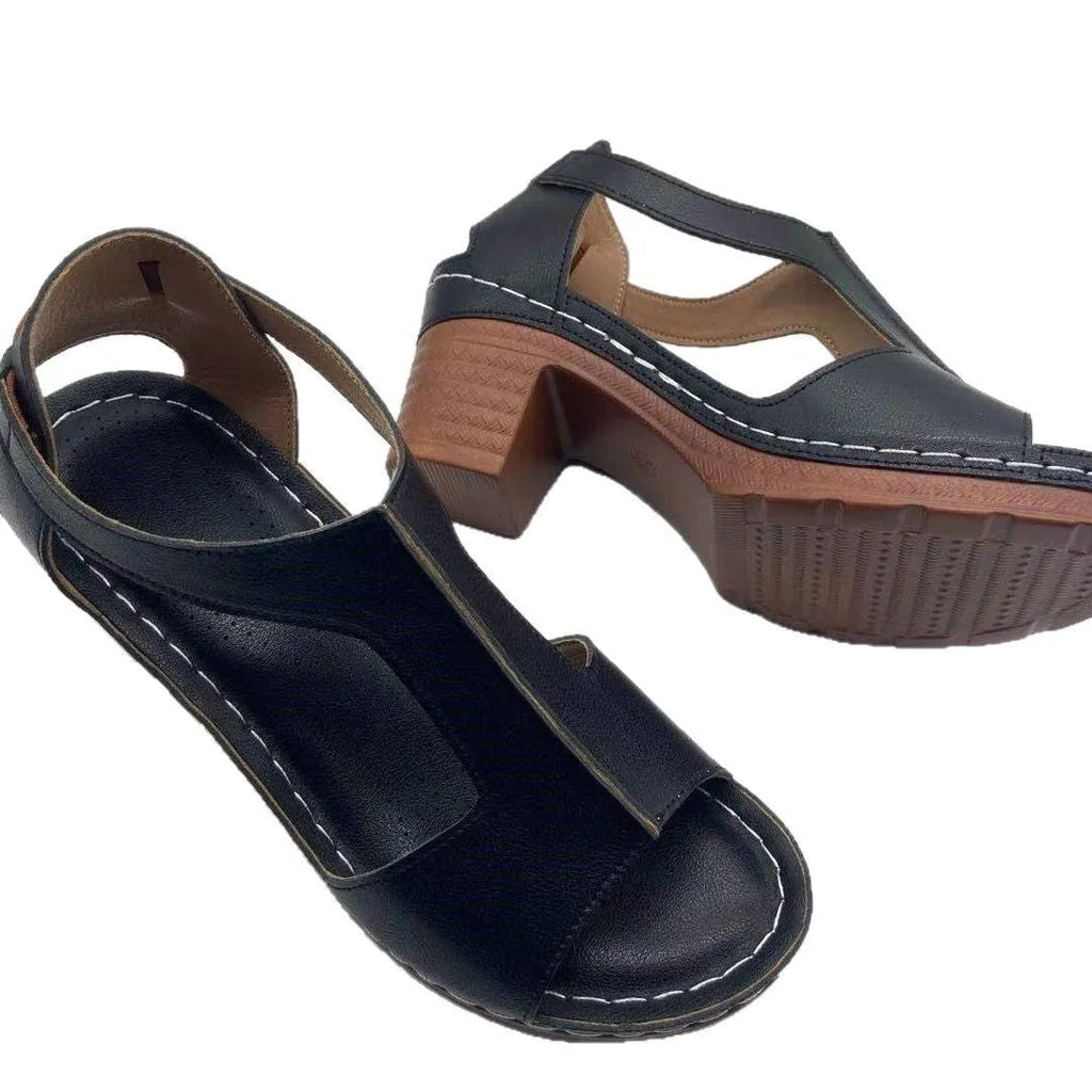 Women's beige peep toe wedge sandals with a buckle strap, shown on a foot.