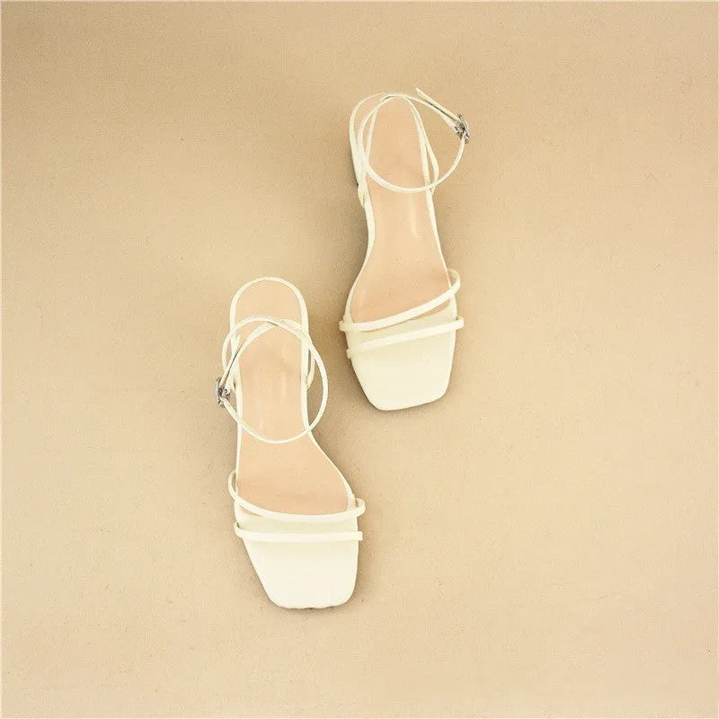 Beige women's stiletto sandals with chunky heel, square toe, and ankle buckle.